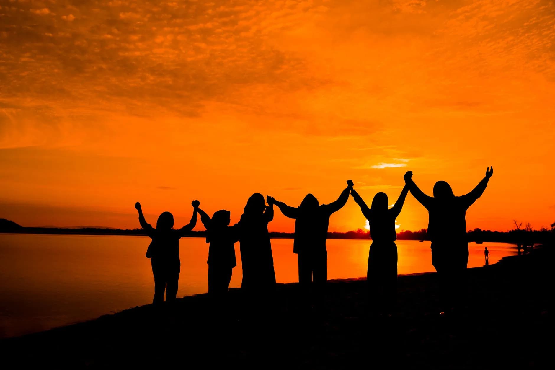 People standing together at sunset