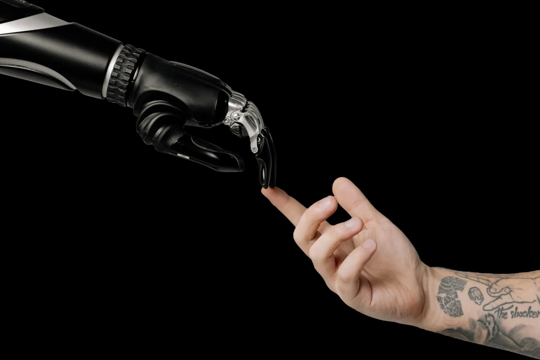 A human hand reaching toward a robotic hand